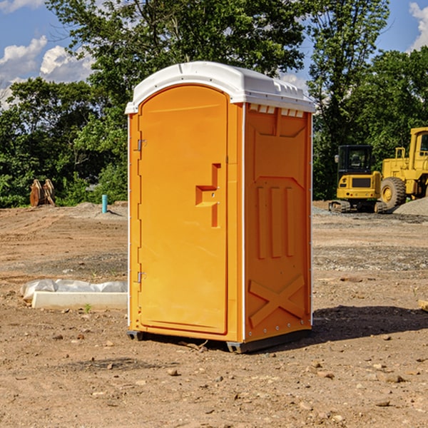 what is the cost difference between standard and deluxe portable restroom rentals in Brainard